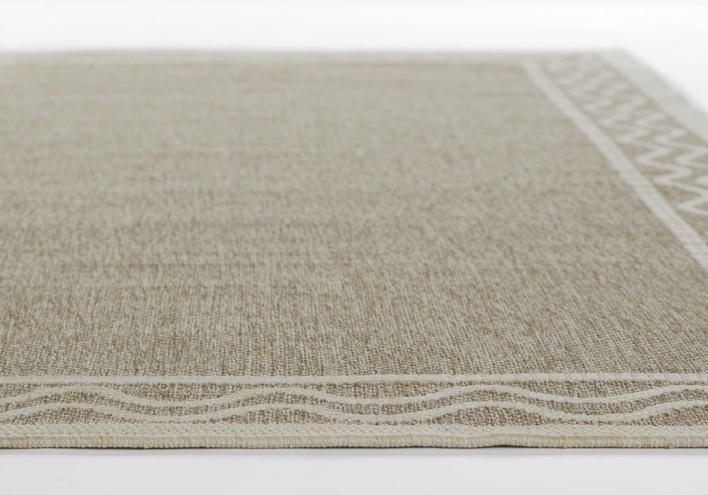 Beige-gray flatweave runner rug with natural fiber texture; bottom edge features a wavy border and right-edge geometric trim.