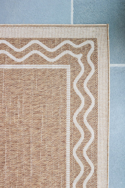 Natural jute rug with white wavy border and striped frame; rectangular, textured weave for casual living spaces.