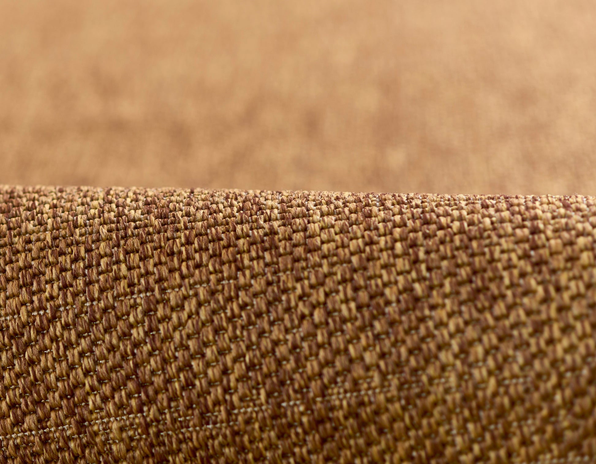 Close-up of natural brown woven fabric with tight texture, rustic upholstery material.
