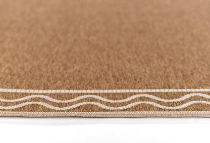 Natural cork mat with white wavy border on brown textured surface, perfect for entryway or decor.
