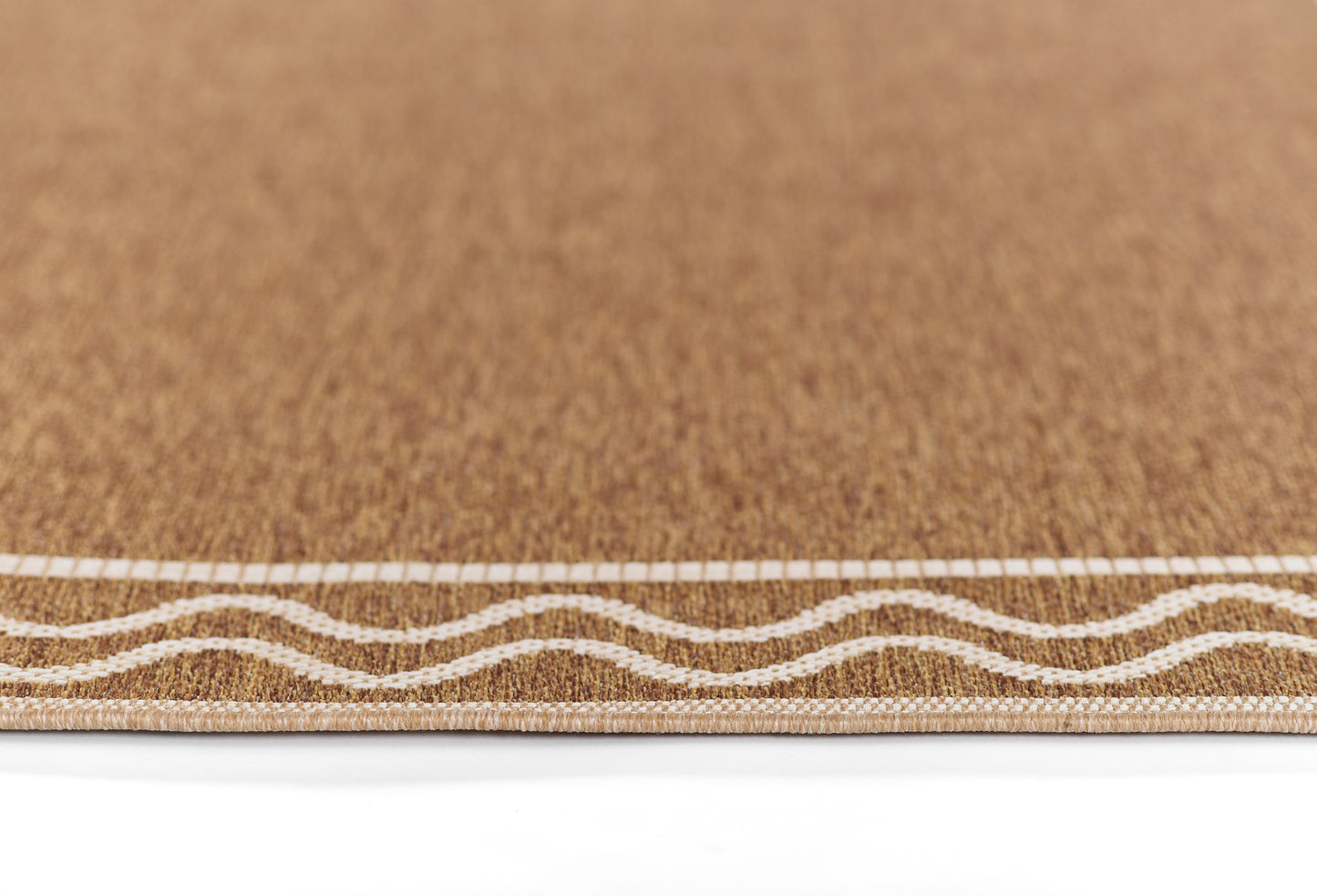 Natural cork rug with white wavy trim along the edge.