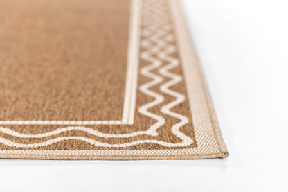 Close-up of natural brown woven rug with white zigzag border and textured surface.