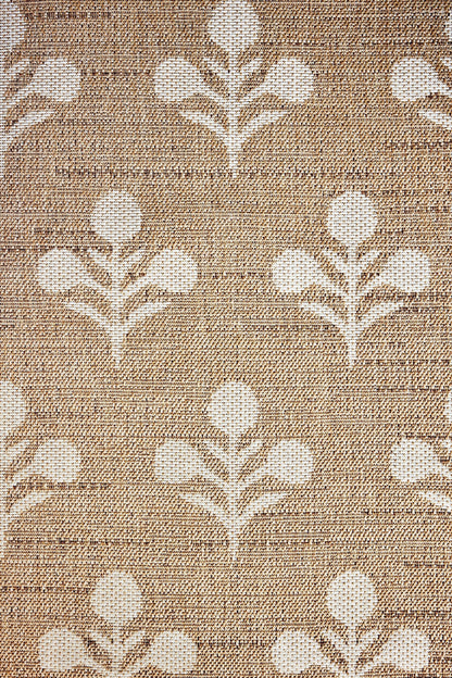 Beige woven rug with repeating white tulip-like floral motifs on a textured background.