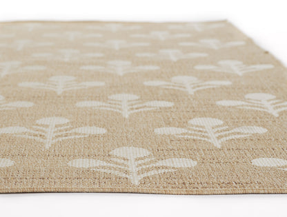 Beige woven jute rug with white stylized leaf/flower motifs in a repeating pattern.