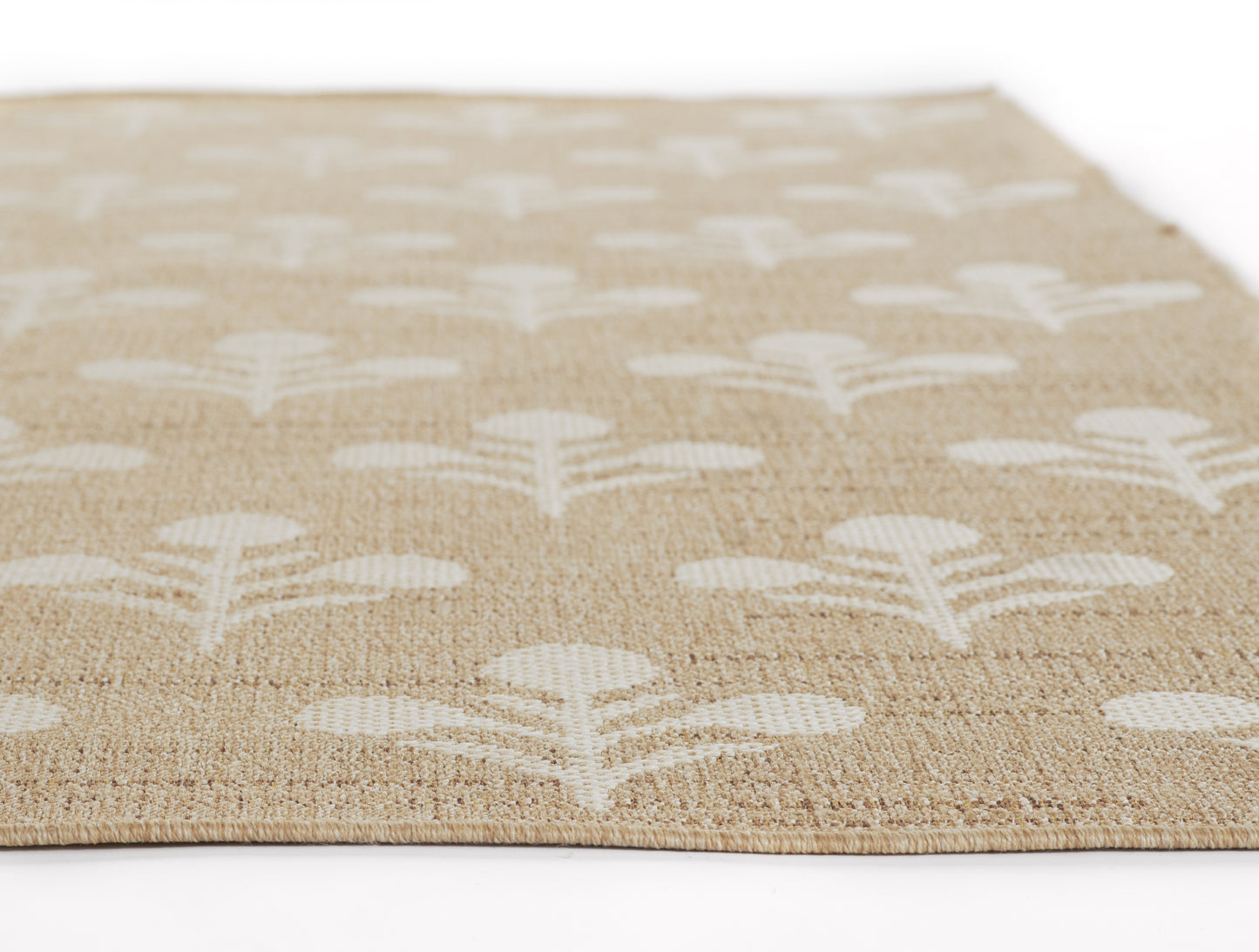 Natural jute rug with white leaf motif pattern; low-pile rectangle rug for living room decor.