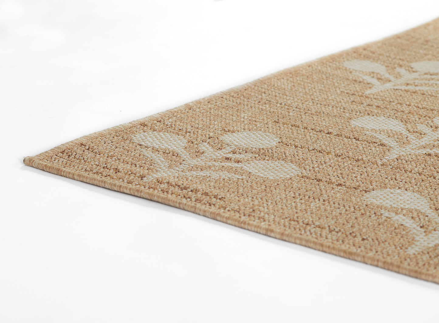 Beige natural-fiber rug with white leaf motif, woven texture, rectangular shape, boho living room decor.