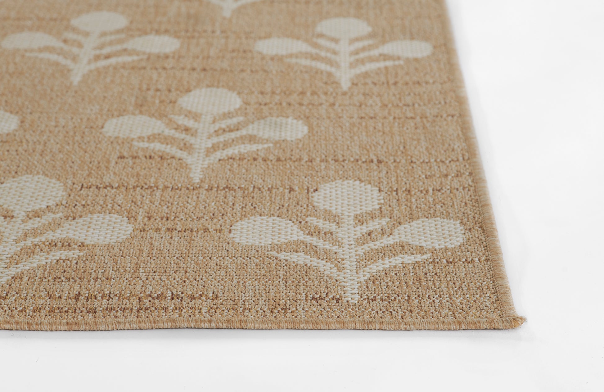 Beige woven jute rug with white botanical leaf pattern, rectangular, low-pile texture.