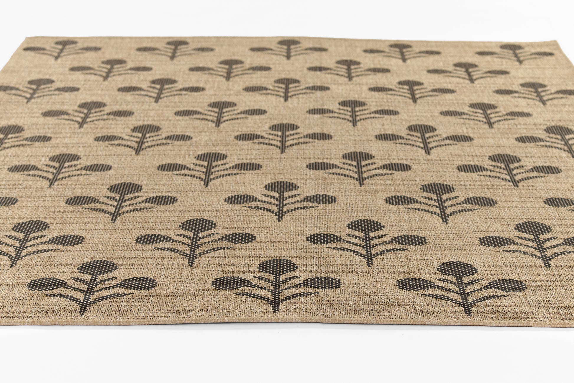 Beige natural jute area rug with repeating black stylized tree motifs.