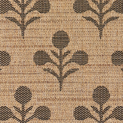 Natural tan woven rug with black stylized botanical floral motifs, textured jute look for rustic decor.