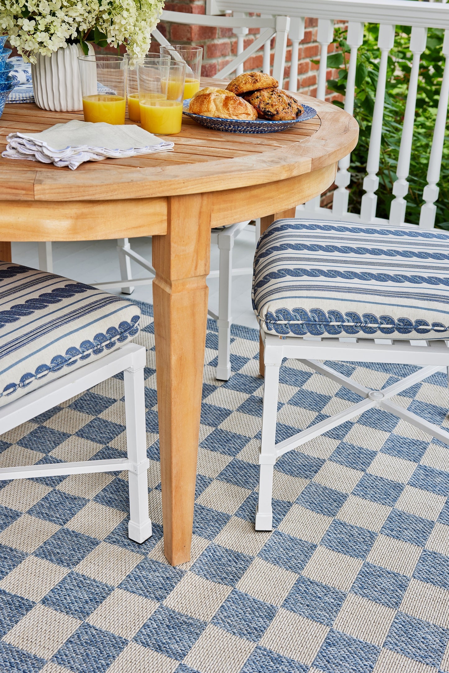 Blue outdoor rug on a patio.