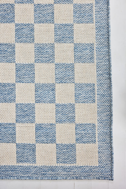 Blue and cream checkerboard woven rug with a blue border.