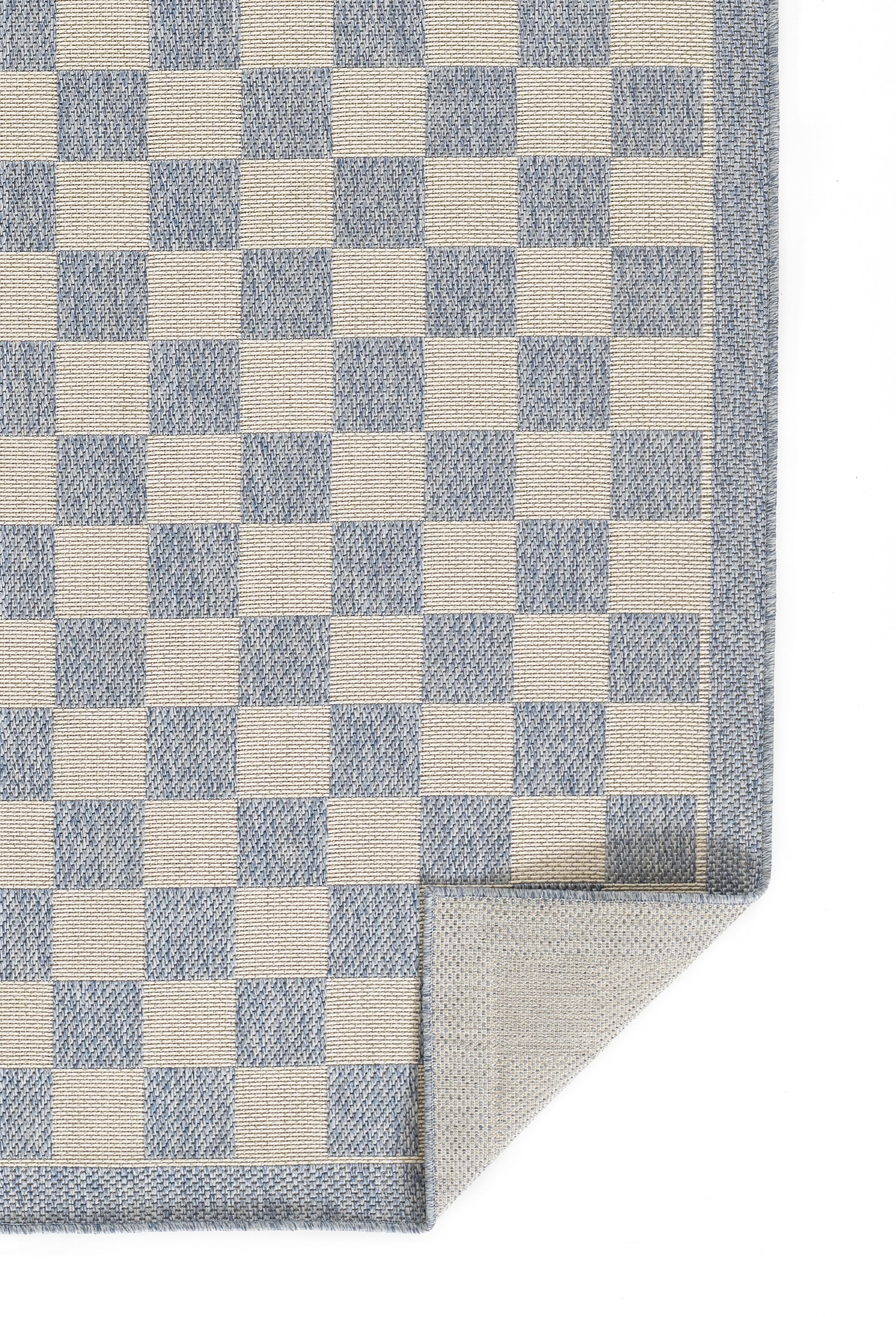 Blue and white checker rug with a denim-blue border and folded corner.