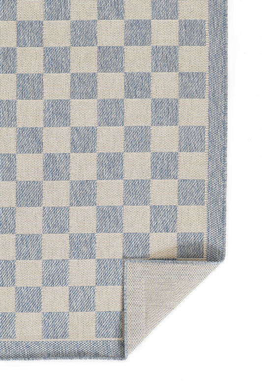 Blue and white checker rug with a denim-blue border and folded corner.
