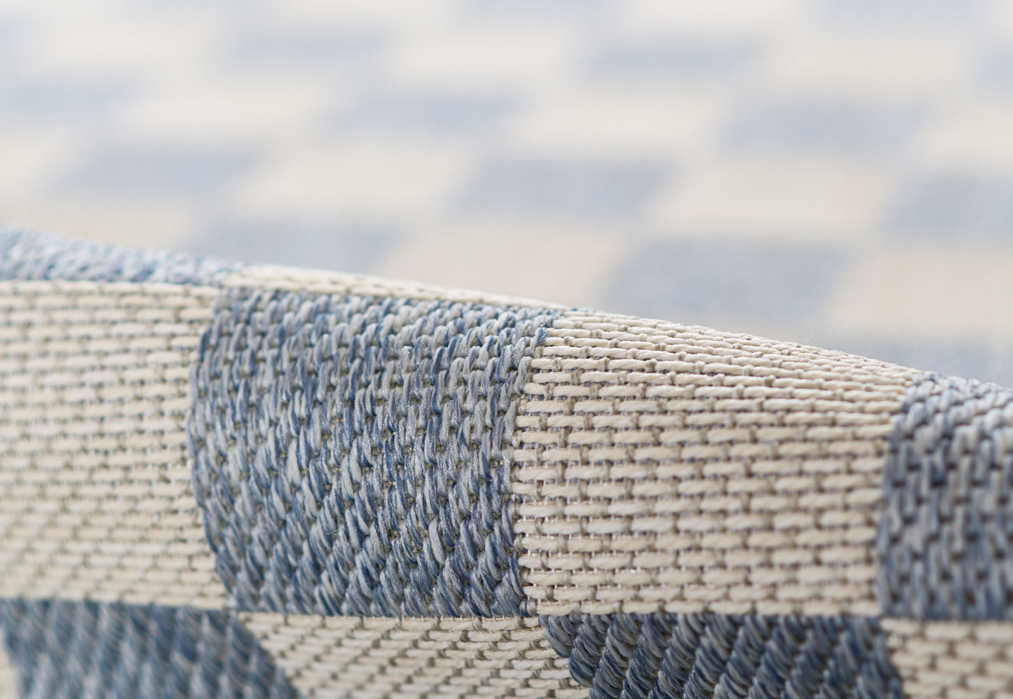 Close-up of blue and beige striped woven rug with a chunky texture, 7' x 9'.