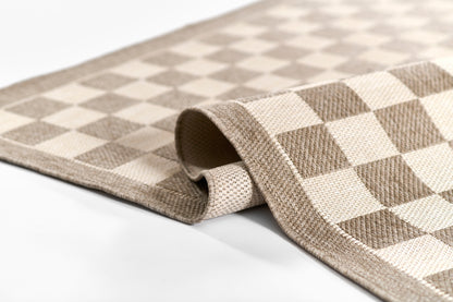Beige and ivory checkerboard woven rug with rolled edge; rectangular.