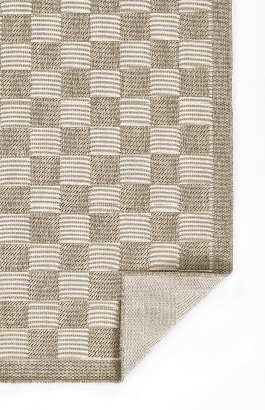 Beige and taupe checkered woven rug with bound edges; folded corner visible.