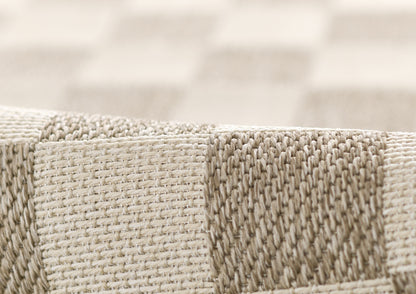 Beige and gray striped woven rug with thick, textured weave and edge seam.