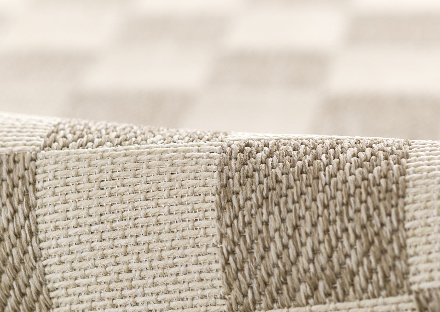 Close-up of beige and gray striped woven fabric with chunky texture, suitable for rug or upholstery.