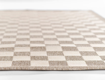 Beige and ivory checkerboard rug with woven texture and light border, rectangular rug for living room or entryway.