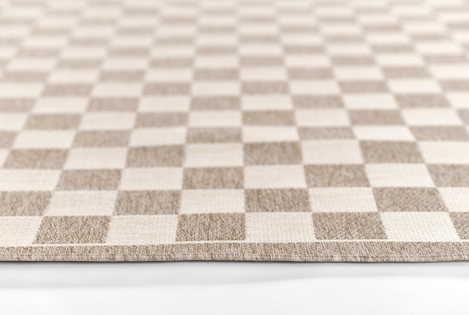 Gray and beige checkered woven rug with soft texture and neat edge.