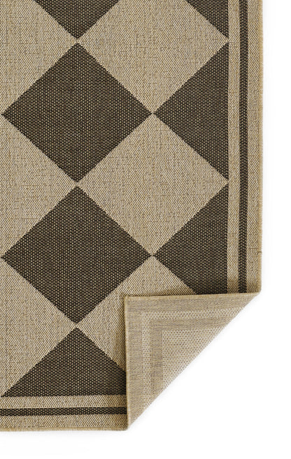 Jute-look woven rug with tan and dark brown diamond pattern, beige border, folded corner revealing backing.