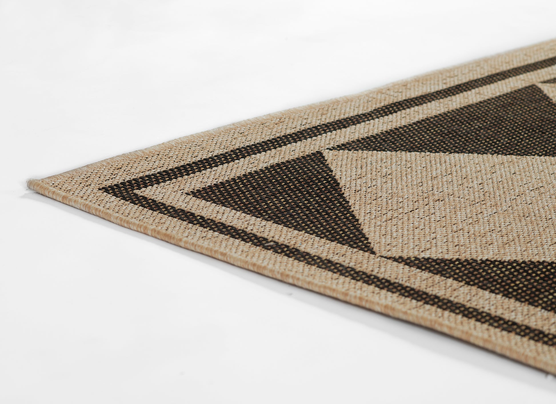 Natural jute rug with black geometric triangles and border, rectangular floor rug.