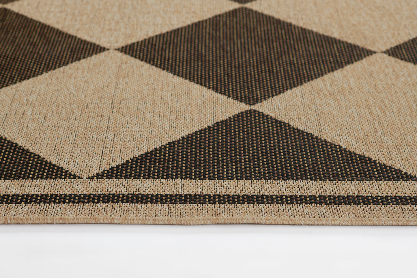 Beige and black woven rug with large argyle diamonds; geometric, natural fiber texture, bordered.