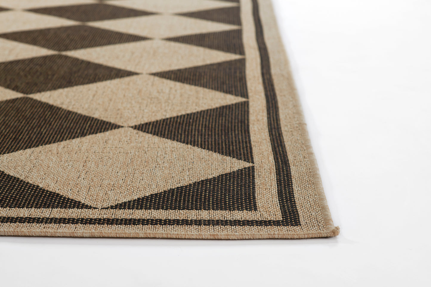 Beige and black diamond-pattern rug with striped border; rectangular, woven, flat-weave texture.