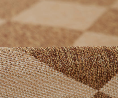 Natural beige-brown woven rug with textured jute fibers and diagonal fold detail.