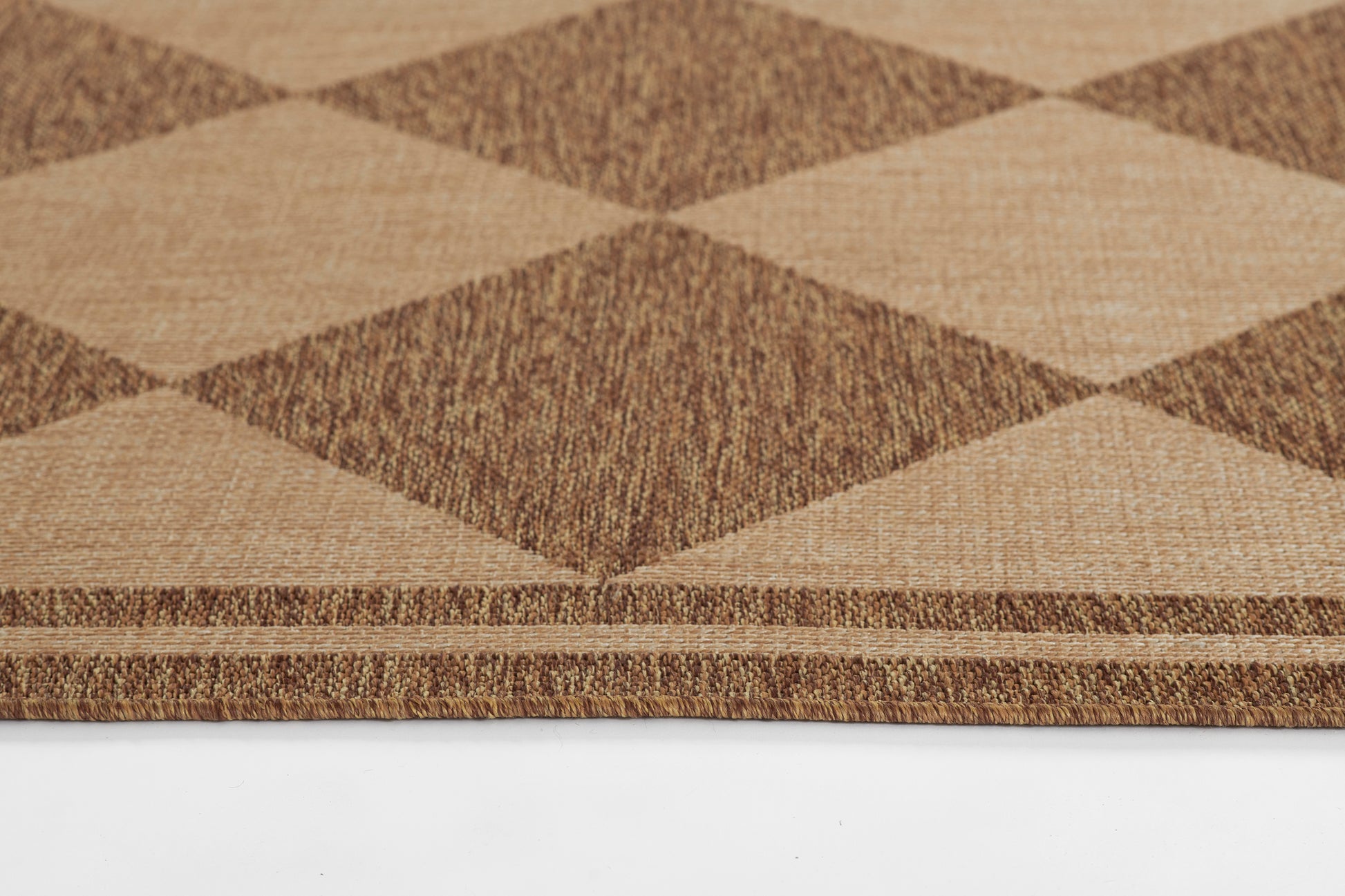 Natural brown and tan diamond-pattern doormat with woven texture, ideal for entryways.