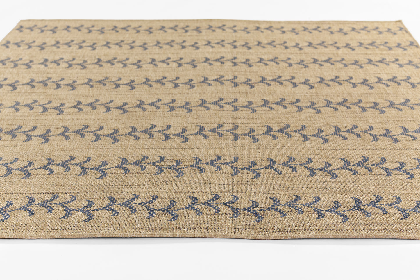 Beige flat-weave jute rug with blue leaf pattern; rectangular coastal boho area rug.