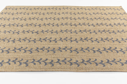 Beige flat-weave jute rug with blue leaf pattern; rectangular coastal boho area rug.