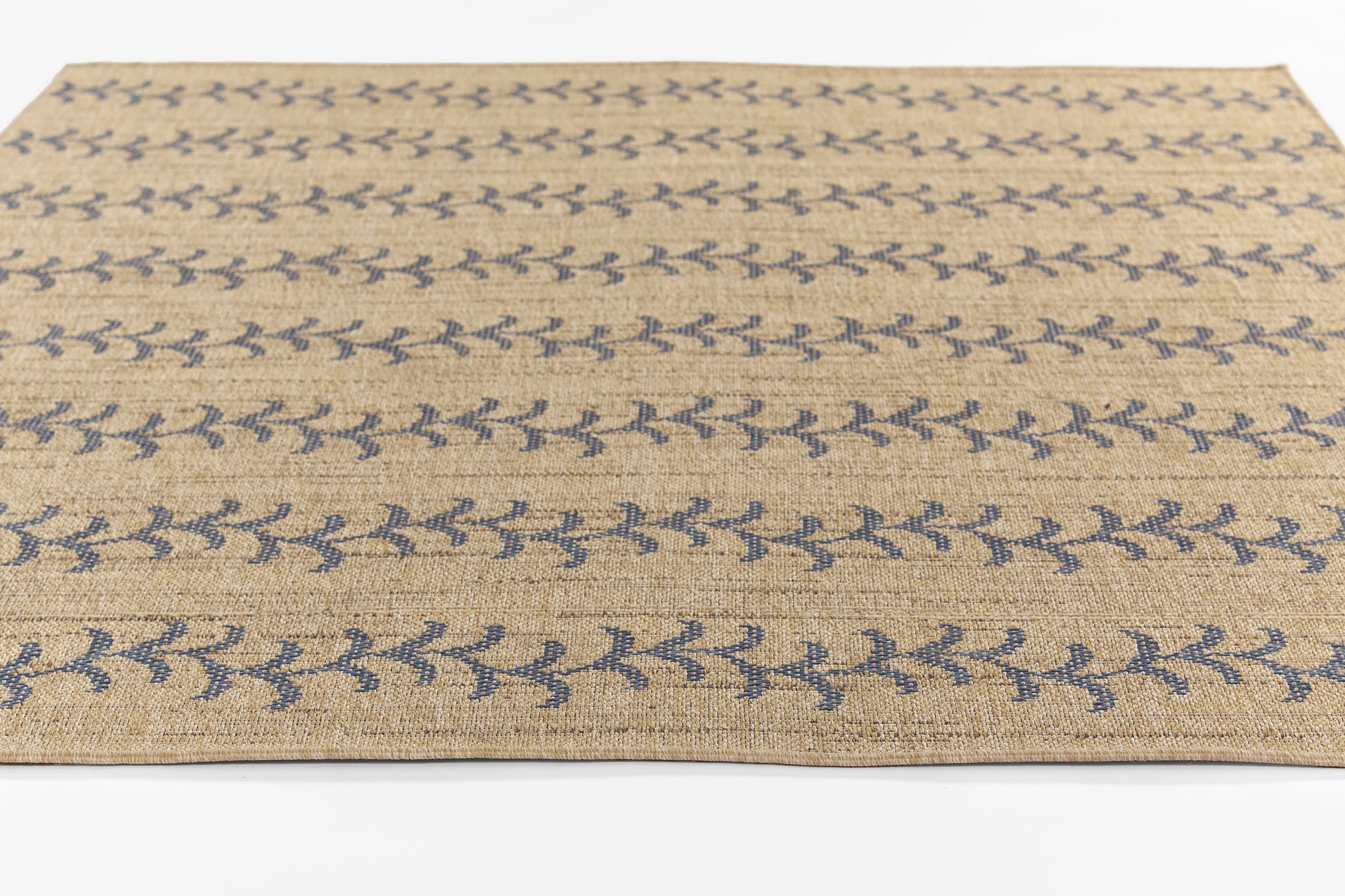 Beige jute area rug with blue leafy vine stripe pattern, rectangular rustic boho style.