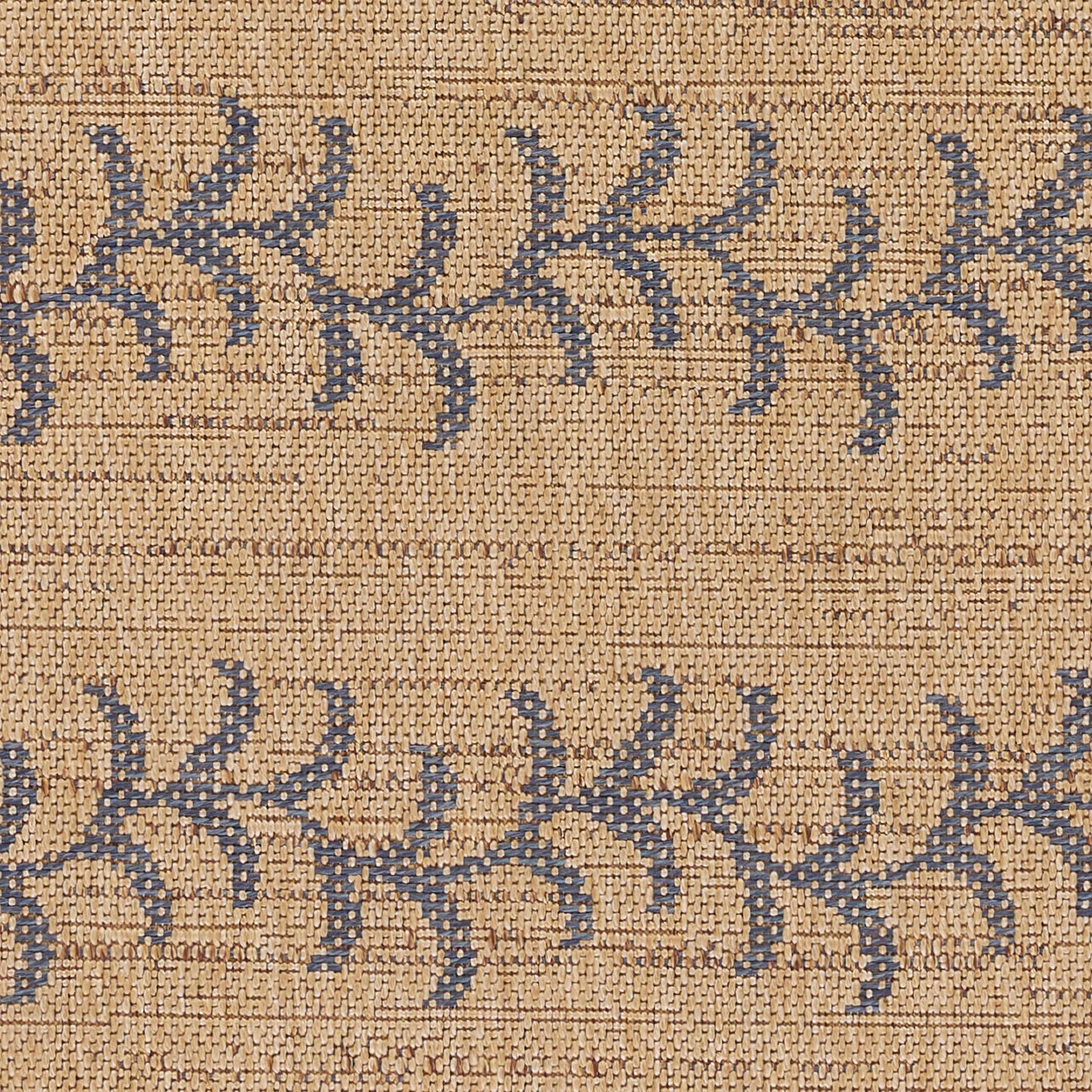 Beige jute rug with blue branch-like pattern in horizontal stripes.