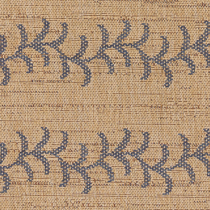 Natural jute rug with indigo blue geometric leaf motifs; rectangular boho-style decor.