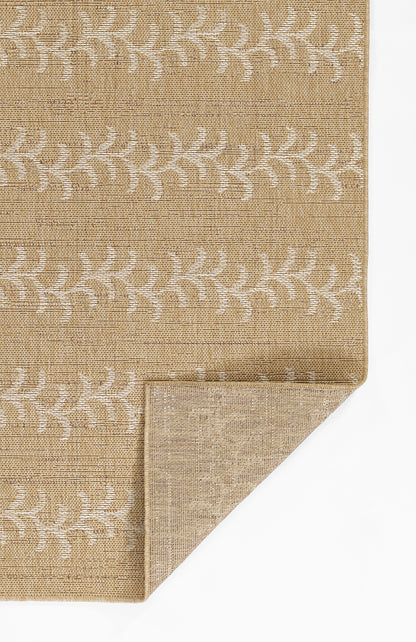 Beige textured woven rug with white leaf motif; natural fiber look, corner folded to reveal underside.