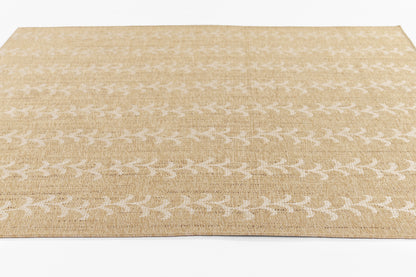Beige woven rug with white leafy pattern, rectangular jute-style rug for living room decor.
