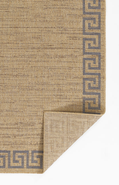 Beige textured woven rug with dark blue Greek key border and a folded corner.