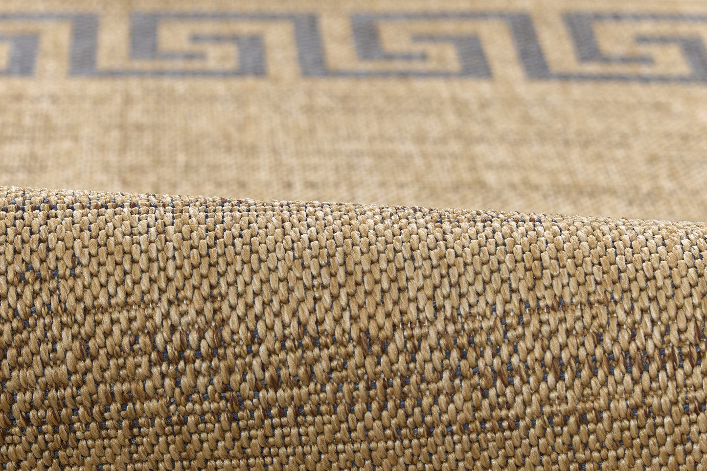 Beige natural-fiber woven rug with blue Greek-key border; textured, rolled edge.