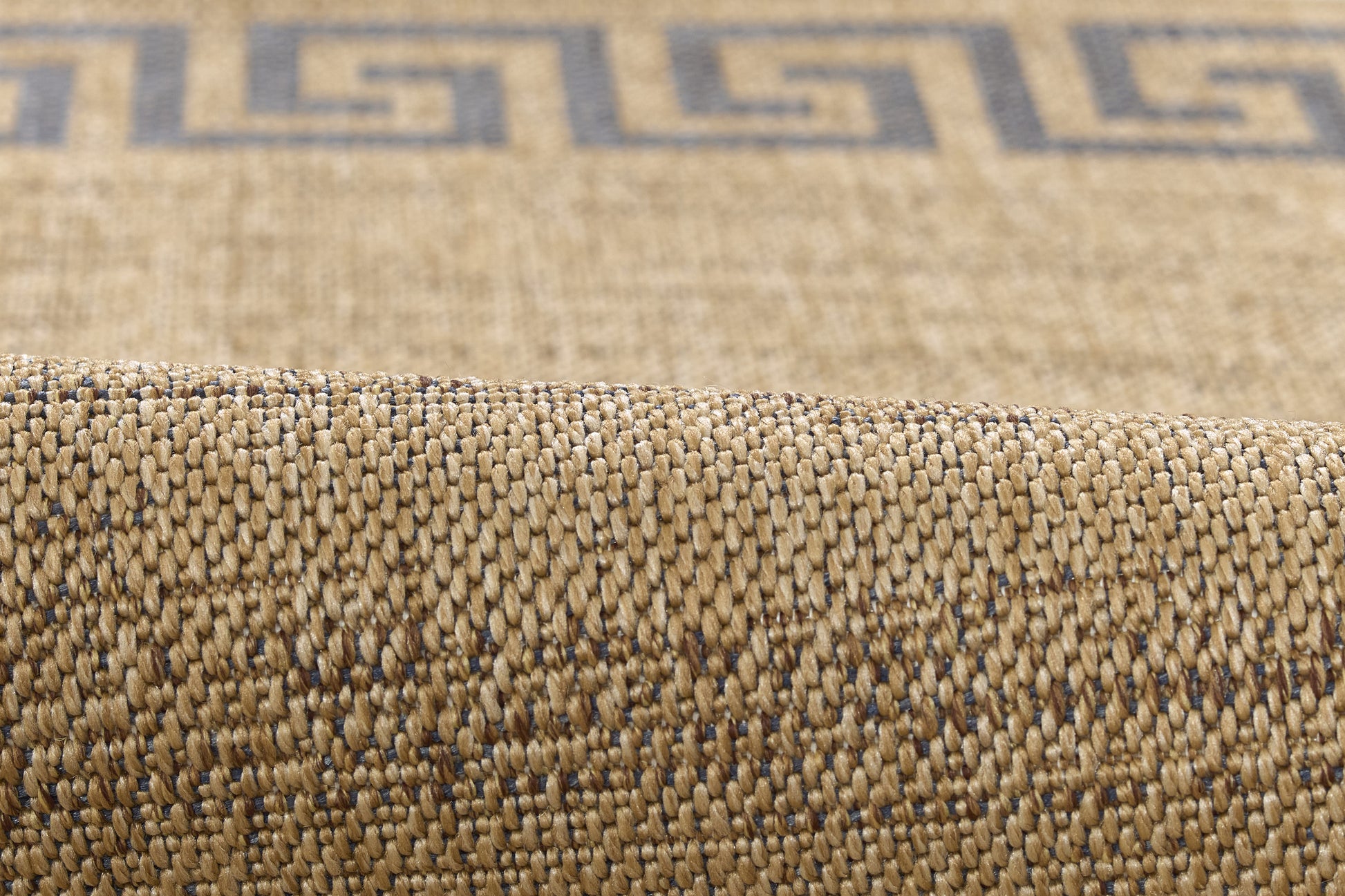Beige natural-fiber woven rug with blue Greek-key border; textured, rolled edge.