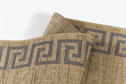 Natural jute rug with black Greek-key border, woven texture; rolled corner.