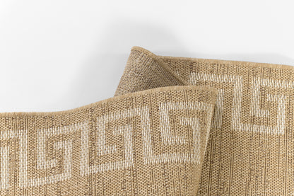 Natural jute rug with cream Greek key border, beige woven texture; folded corner.