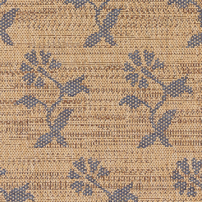 Tan woven rug with blue floral vine pattern; textured jacquard tapestry look, decorative home accent.