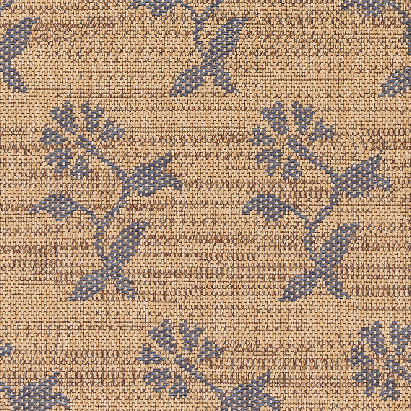 Beige woven rug with blue floral vine pattern; textured decorative floor covering.