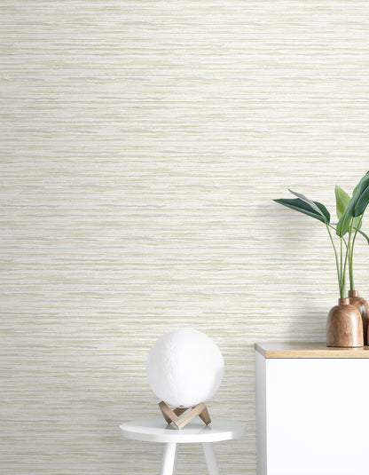 Coastal beige sisal rug with Skye Wave pattern, shown in a neutral room setting with wooden furniture and a plant.
