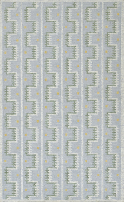 Scandinavian blue geometric rug with white zigzag stair-step motif and tiny yellow dots in vertical repeats.