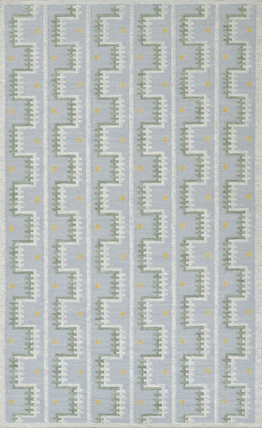Scandinavian blue geometric rug with white zigzag stair-step motif and tiny yellow dots in vertical repeats.