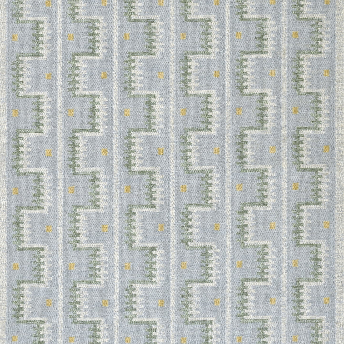 Blue Scandinavian-patterned rug with white zigzag staircase motif, pale green accents and small yellow squares.