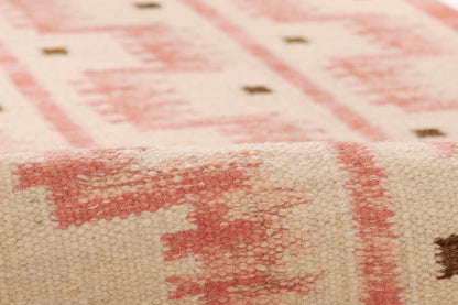 8' x 10' beige woven rug with pink geometric motif, soft texture and small brown accents; Scandinavian-style floor decor.