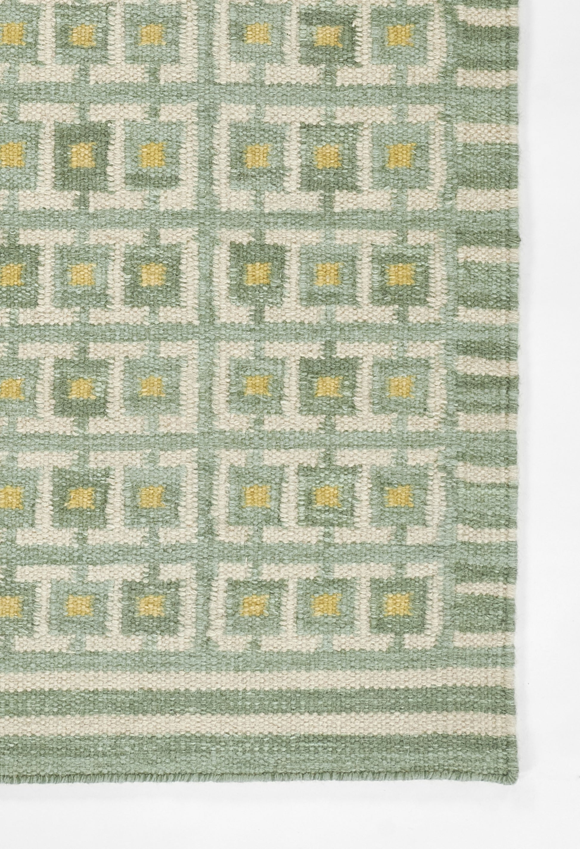Woven rug in sage green and cream geometric square-grid pattern with yellow accents and a striped border, 5' x 8'.